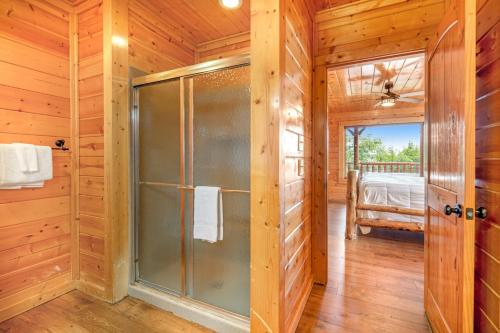 a bathroom with a shower in a log cabin at The Sweet Escape in Sevierville