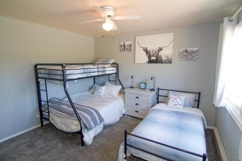 a bedroom with two bunk beds and a cow on the wall at Fish Hatchery Ranch in Hatch