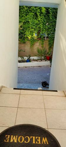 a door leading into a yard with a swimming pool at Antonia's cozy apartment in Agia Triada