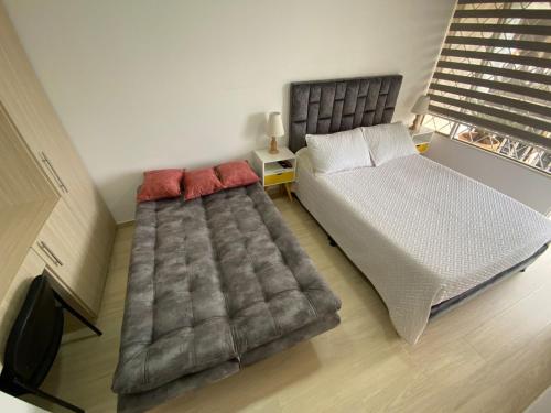 Postel nebo postele na pokoji v ubytování Habitaciónes Casa Holiday Fusa