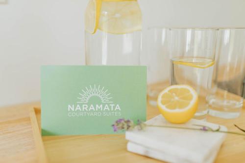 a glass of water and a lemon on a table at Naramata Courtyard Suites in Naramata