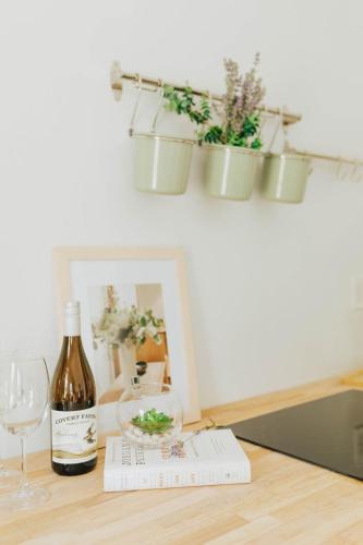 a bottle of wine and glasses on a table at Naramata Courtyard Suites in Naramata
