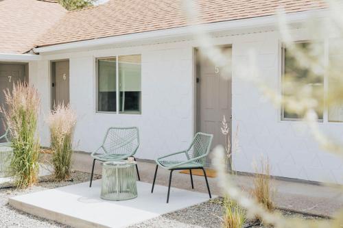 two chairs sitting in front of a house at Naramata Courtyard Suites in Naramata