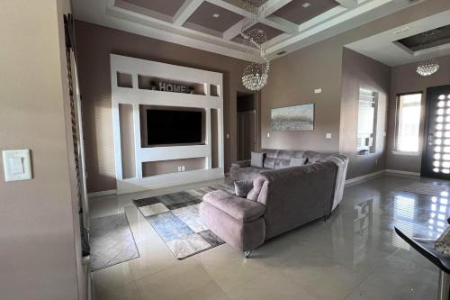 a living room with a couch and a tv at Timeless Memories in Los Fresnos