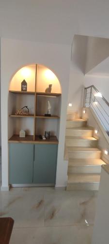a staircase with a book shelf and a stair case at Elais Luxury Villas in Parga