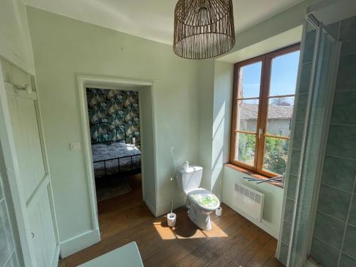 une salle de bain avec toilettes et fenêtre dans l'établissement Le Clos des Cadots - Chambre, à Chaintré