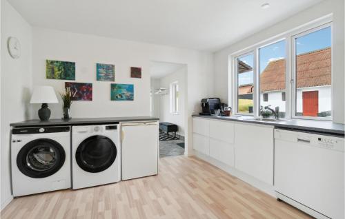 a white laundry room with a washer and dryer at Gorgeous Home In Hasle in Hasle