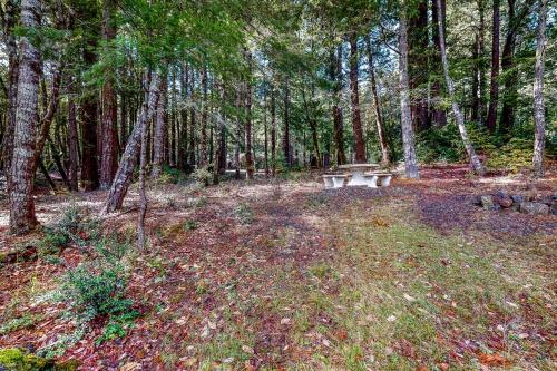 a picnic table in the middle of a forest at Artist's Retreat in Jenner