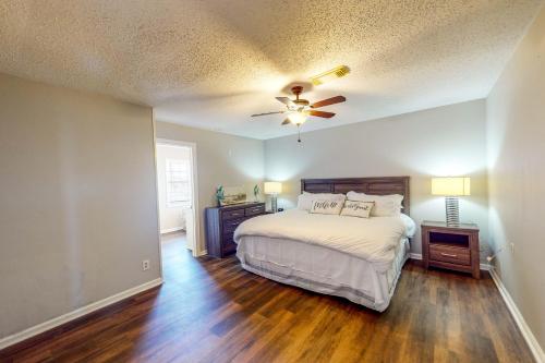 a bedroom with a bed and a ceiling fan at Gators, Fishes, Beaches, and Birds in Freeport