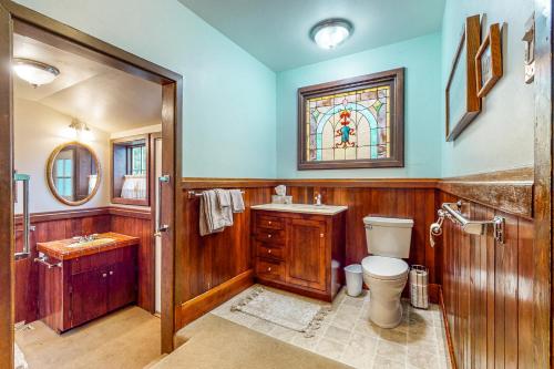 uma casa de banho com um WC, um lavatório e um vitral. em Forbestown B&B em Lakeport