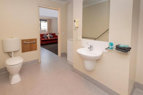 a bathroom with a toilet and a sink at BIG4 Hobart Airport Tourist Park in Cambridge