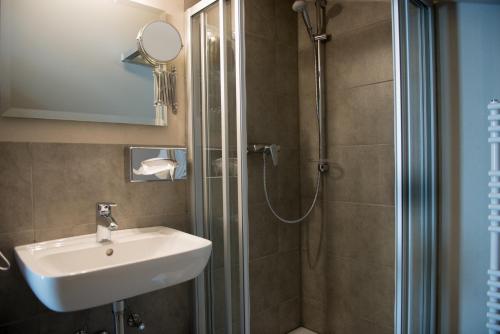 a bathroom with a sink and a shower at Hotel Restaurant Brigitte in Warmensteinach