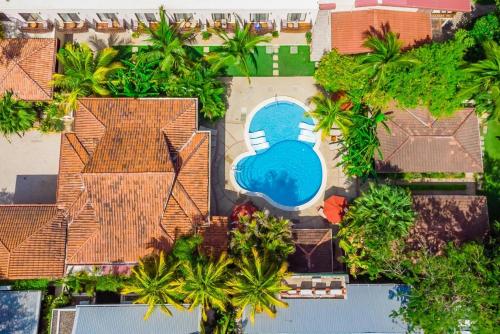 an aerial view of a house with a swimming pool at The Coast Beachfront Hotel in Tamarindo