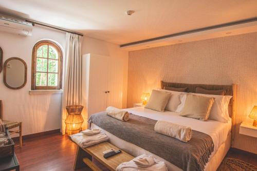 a bedroom with a large bed and a window at Villa Pietra Estoril Eco Guesthouse in Estoril