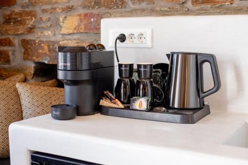 a counter with two coffee makers on a table at KL , Cozy Suite II in Kithnos