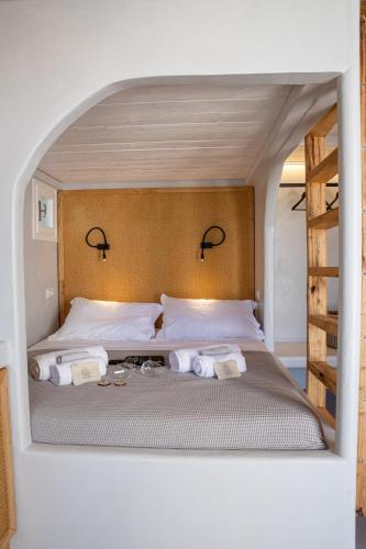 a bedroom with a bed with towels on it at KL , Cozy Suite II in Kithnos