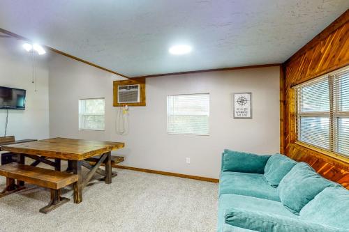 a living room with a blue couch and a table at Amani in Onalaska