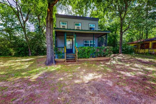 a blue house with a tree in the yard at Amani in Onalaska