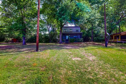 a house in the middle of a yard with trees at Amani in Onalaska