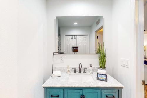 a bathroom with a sink and a mirror at Hop Top Rental in Orlando