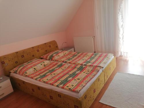 a bed in a small room with a box bed at Anna Vendégház in Balatonőszöd