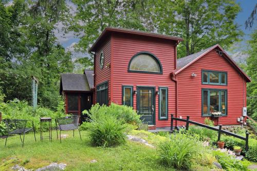 a red house with chairs in front of it at Berkshire Retreat- A stone's throw to downtown Lenox in Stockbridge