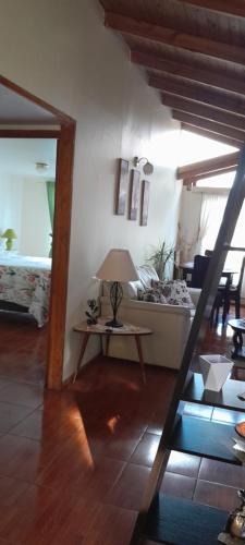 a living room with a table and a couch at Encanto Rural - Casa de campo para disfrutar y olvidar el estrés in Putaendo