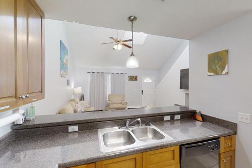 a kitchen with a sink and a counter top at Sugar Berry Suites in Tallahassee