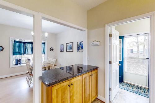 a kitchen with a counter and a dining room at Satterfield Boathouse in Donalsonville