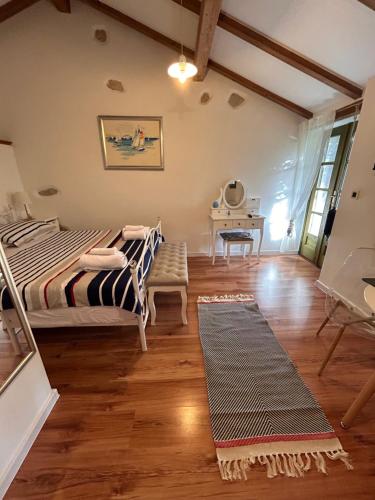 a bedroom with a bed and a desk in a room at Gaya apartments in Šibenik