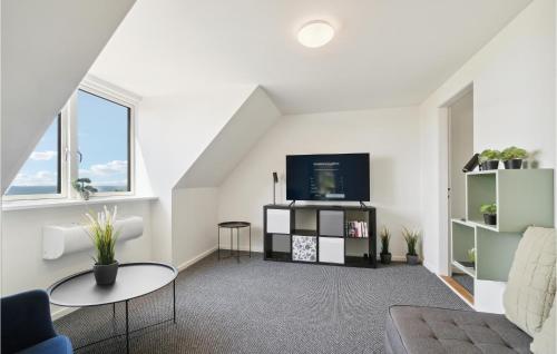 a living room with a tv and a couch at Gorgeous Home In Hasle in Hasle