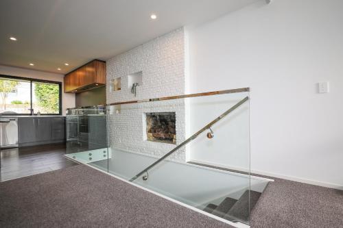 a kitchen with a glass counter and a fireplace at Redwoods Getaway in Rotorua