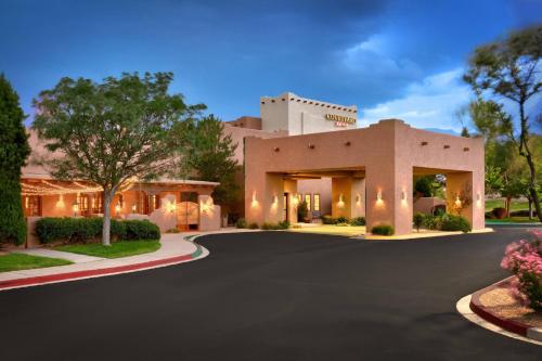 a house with a driveway in front of it at Courtyard by Marriott Albuquerque in Albuquerque