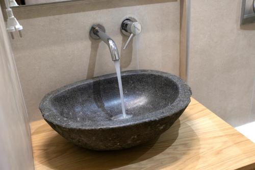 a stone sink with a faucet in a bathroom at Elais Luxury Villas in Parga