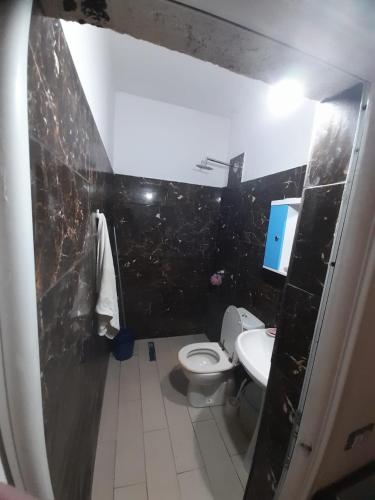 a small bathroom with a toilet and a sink at Rey Garden 2 in Vlorë
