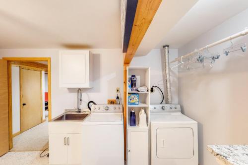 a white laundry room with a washer and dryer at Autumn Hill Lakehouse in Hinsdale