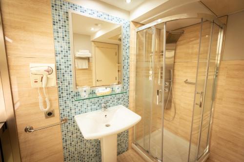a bathroom with a sink and a shower at Hotel Montedobra in Torrelavega