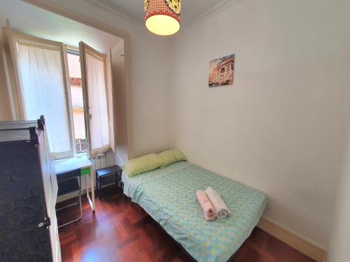 a small bedroom with a bed with two towels on it at Holiday House Naiadis in Rome