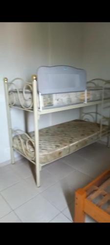 a room with a shelf with a suitcase on it at Apartamento frente ao mar!!! in Itanhaém