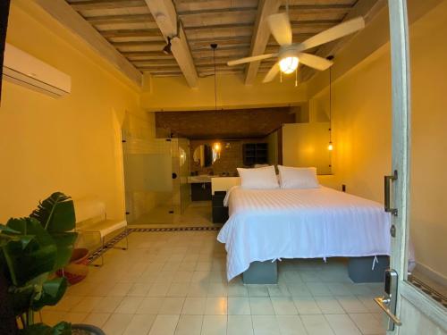 a bedroom with a large white bed in a room at Casa Charlotte - Alma Hotels in Santa Marta