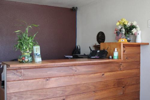 a wooden dresser with flowers on top of it at Flagstaff Motel in Flagstaff