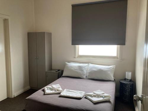 a bedroom with a bed with two plates on it at Inspirations Mullewa in Mullewa