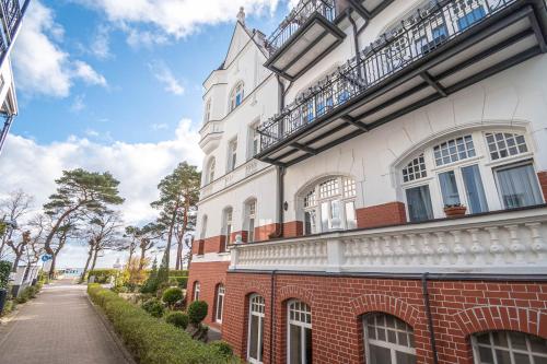 a brick building with windows and balconies on a street at Hotel Imperial Rügen in Binz