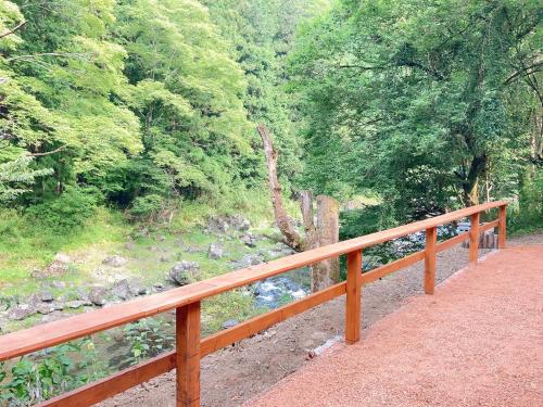 a wooden bridge with a view of a river at 川辺-KAWABE-BBQ-川遊び-fishing in Hanno