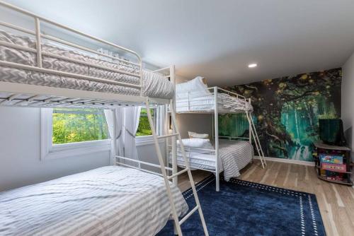 a bedroom with two bunk beds and a mural at Unique Stay! Ricketts Chic Farmhouse Retreat with Stargazing Bubble Tent 