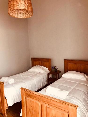 two beds sitting next to each other in a bedroom at 1876 in Chivilcoy