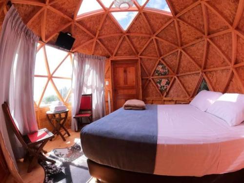 a bedroom with a large bed in a dome shaped room at Hotel Finca Buenos Aires Barichara in Barichara