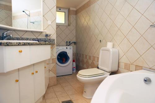 a bathroom with a toilet and a washing machine at Villa in the sea Crete in Stavros