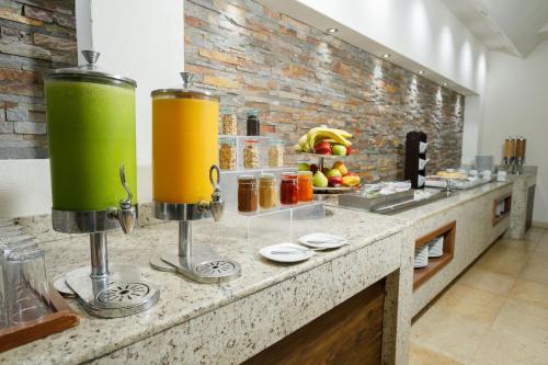 a kitchen with a counter with two large yellow drinks at Real Inn Ciudad Juarez by the USA Consulate in Ciudad Juárez