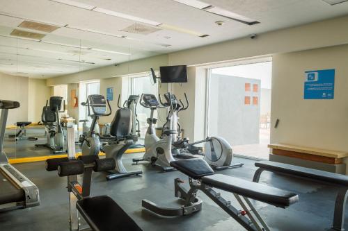 a gym with several tread machines in a room at Real Inn Ciudad Juarez by the USA Consulate in Ciudad Juárez